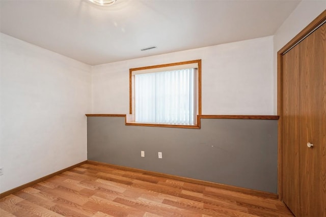 unfurnished bedroom featuring a closet and light hardwood / wood-style flooring