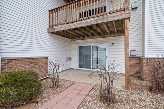 property entrance with a balcony and a patio area