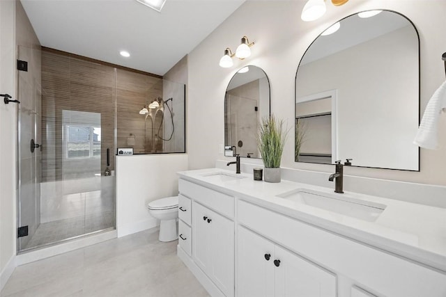 bathroom featuring vanity, toilet, and walk in shower