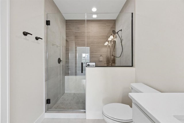 bathroom with vanity, toilet, and walk in shower