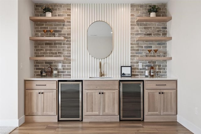 bar with wine cooler, sink, light hardwood / wood-style flooring, and light brown cabinets