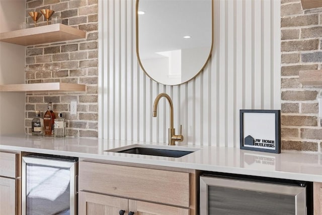 kitchen featuring wine cooler, sink, and light brown cabinets