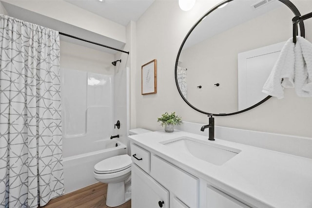 full bathroom with hardwood / wood-style flooring, vanity, shower / bathtub combination with curtain, and toilet