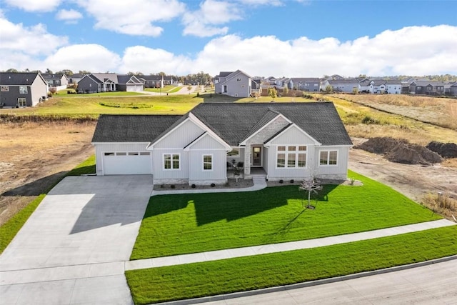 ranch-style house featuring a garage and a front yard