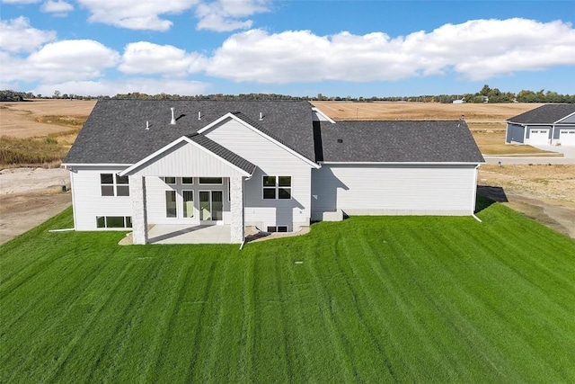 back of house featuring a lawn and a patio