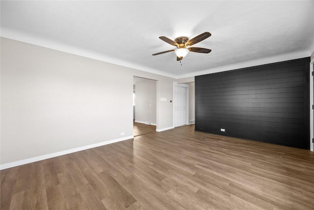 spare room with ceiling fan and hardwood / wood-style floors