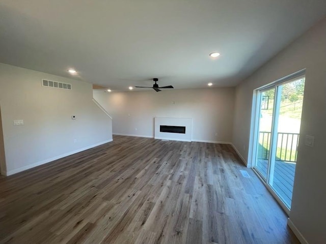 unfurnished living room with light hardwood / wood-style floors and ceiling fan