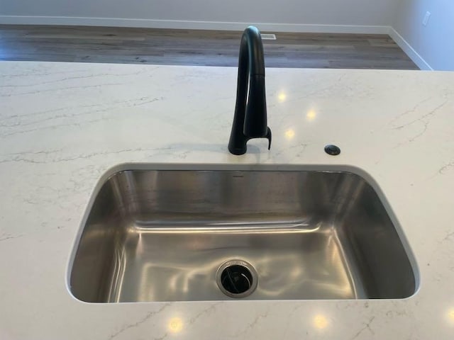 interior details featuring hardwood / wood-style flooring and sink