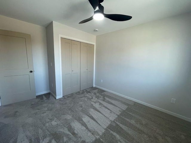 unfurnished bedroom featuring dark carpet, a closet, and ceiling fan