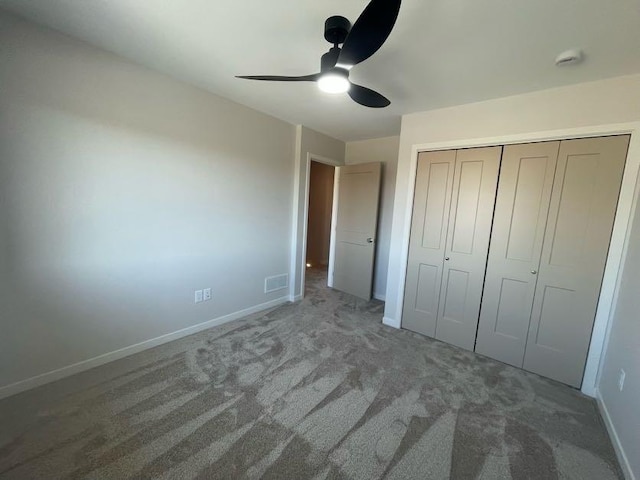 unfurnished bedroom featuring carpet, ceiling fan, and a closet