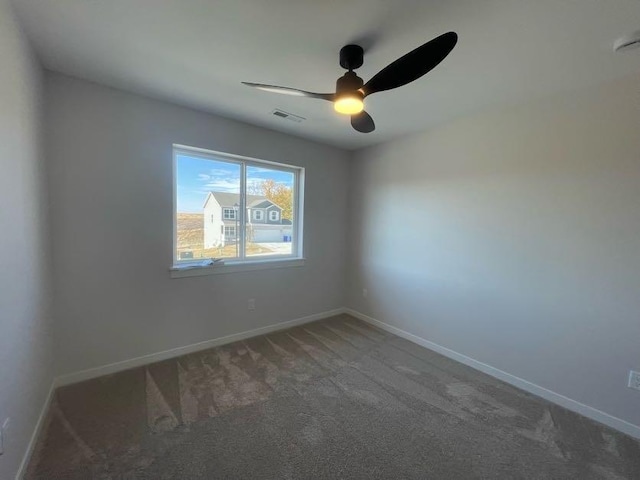 carpeted empty room featuring ceiling fan