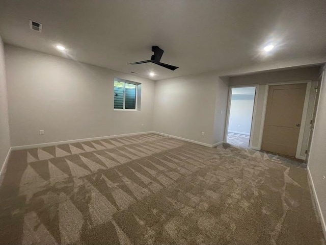 unfurnished room featuring ceiling fan and carpet