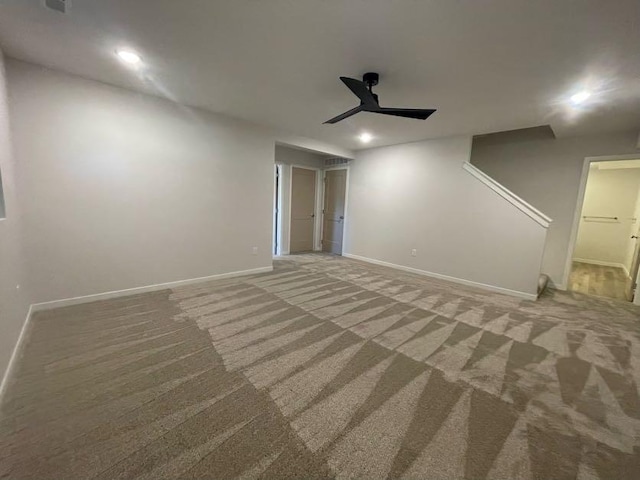 carpeted spare room featuring ceiling fan