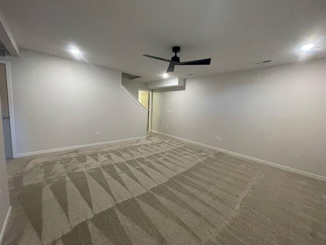 basement with ceiling fan and carpet flooring