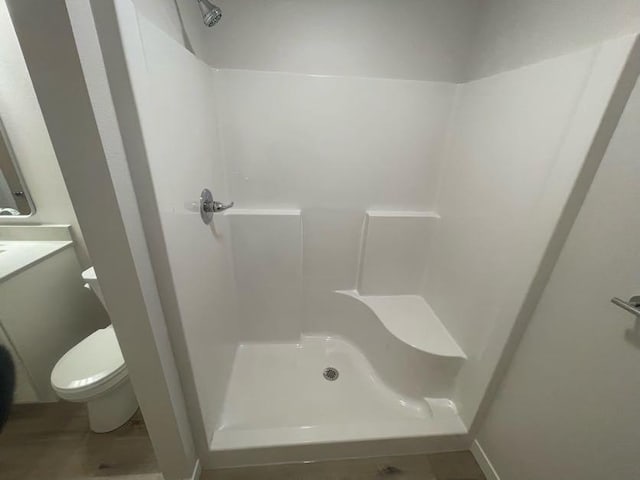 bathroom featuring toilet and walk in shower