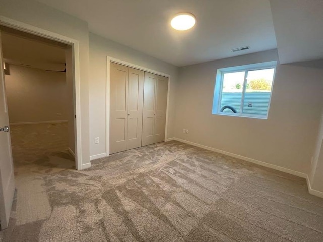 unfurnished bedroom featuring a closet and carpet