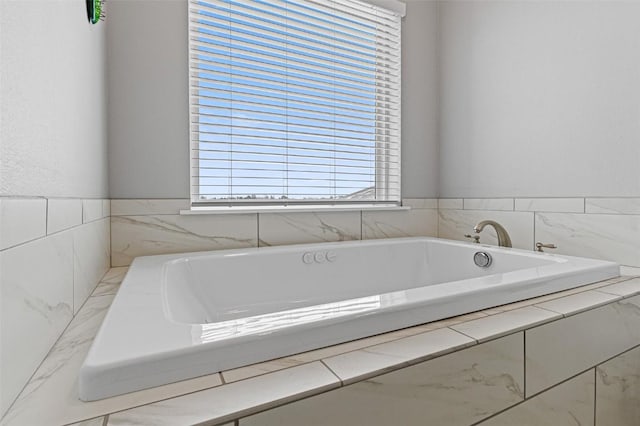 bathroom featuring a relaxing tiled tub