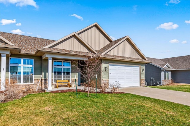 405 Ridge View Dr, West Branch, IA 52358 - craftsman house with stone siding, driveway, a garage, and a front yard