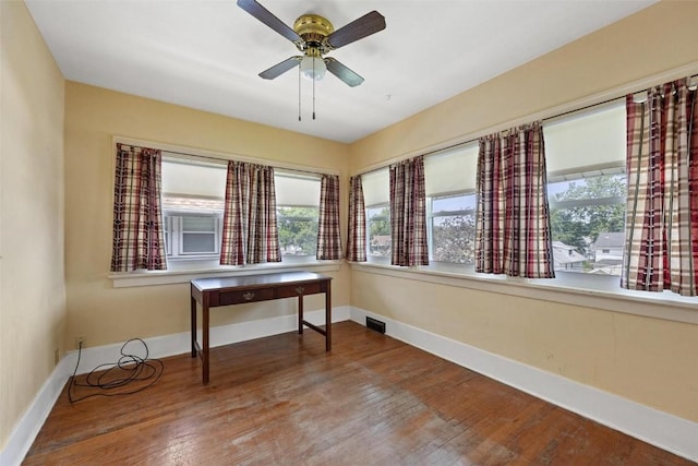 home office featuring hardwood / wood-style flooring and ceiling fan