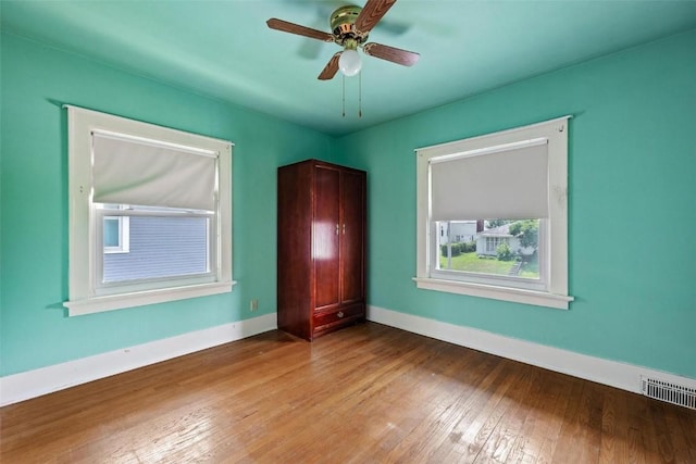 unfurnished bedroom with ceiling fan and wood-type flooring