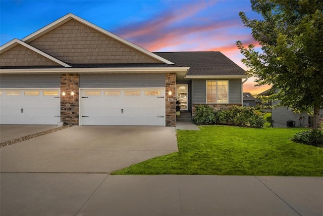 craftsman-style home with a garage and a yard