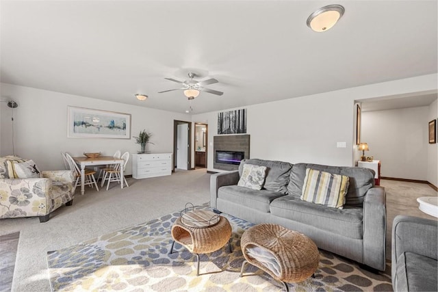 carpeted living room featuring ceiling fan