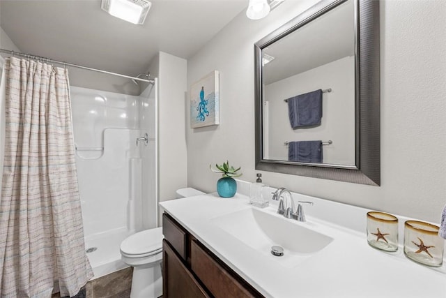 bathroom featuring vanity, toilet, and a shower with shower curtain