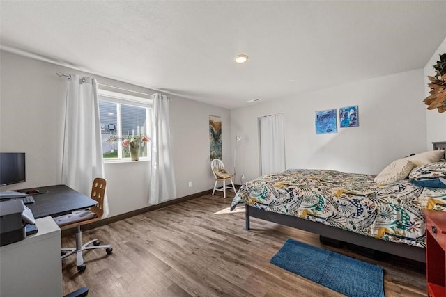 bedroom with hardwood / wood-style flooring