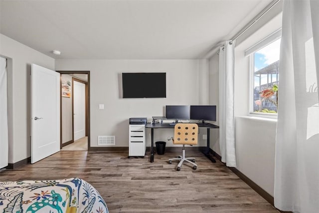 home office with hardwood / wood-style flooring