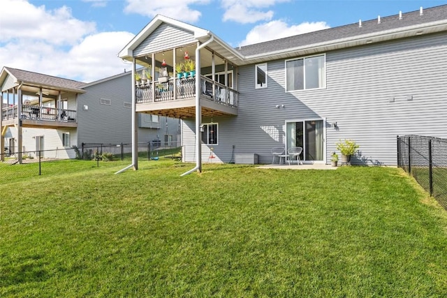 back of property featuring a yard and a patio