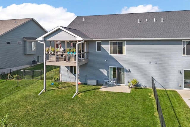 rear view of house with a patio, a yard, and central air condition unit