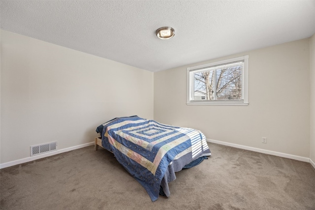 carpeted bedroom featuring a textured ceiling