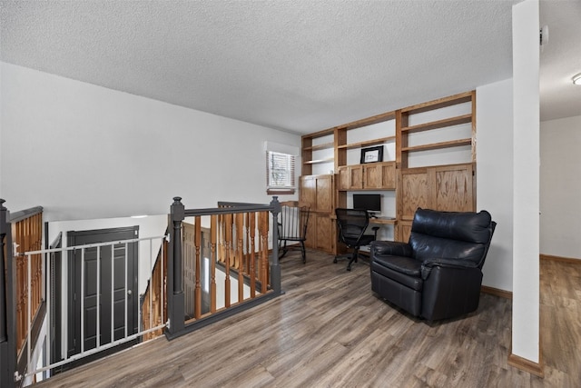 sitting room featuring hardwood / wood-style floors and a textured ceiling