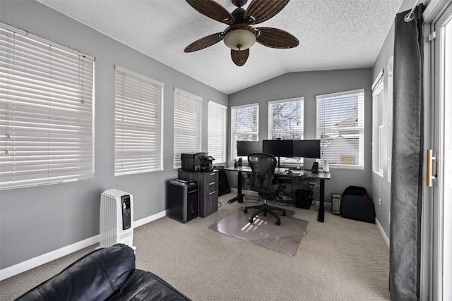 carpeted office space featuring ceiling fan, vaulted ceiling, and a textured ceiling