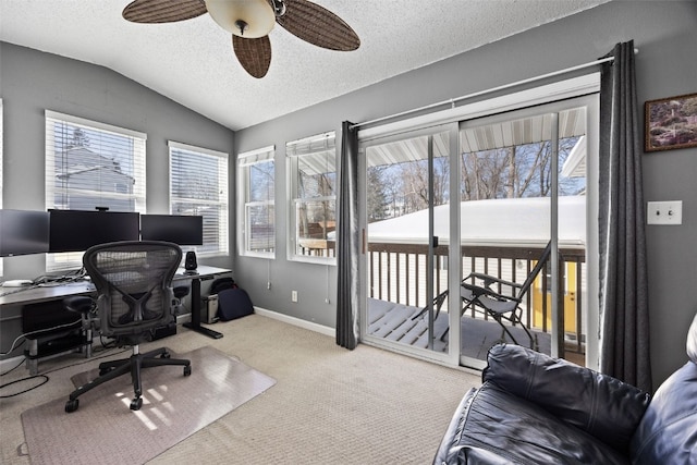 carpeted home office with ceiling fan, lofted ceiling, and a textured ceiling