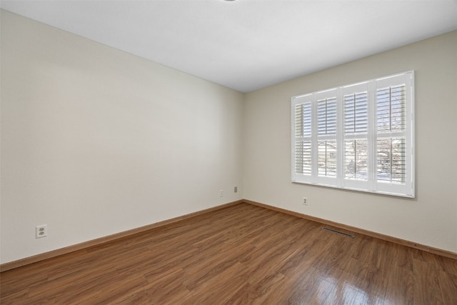 unfurnished room with wood-type flooring