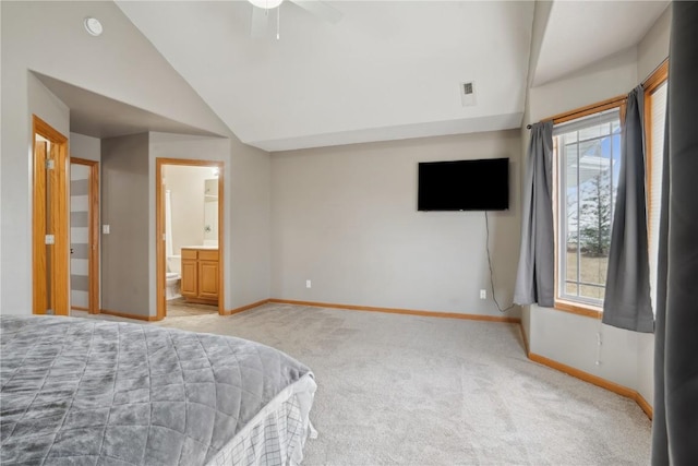 carpeted bedroom with vaulted ceiling and ensuite bath