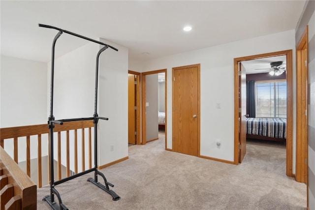 exercise room featuring light colored carpet