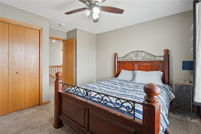 bedroom featuring ceiling fan, light colored carpet, and a closet