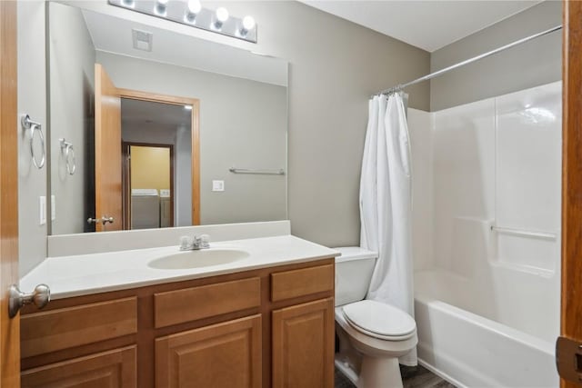 full bathroom with independent washer and dryer, vanity, toilet, and shower / tub combo