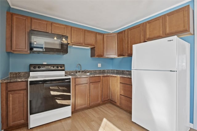 kitchen with light hardwood / wood-style floors, sink, white fridge, and electric range