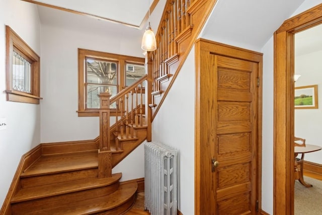 stairs with radiator heating unit and a wealth of natural light