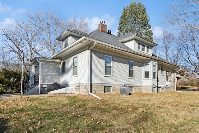 view of side of property featuring cooling unit and a lawn