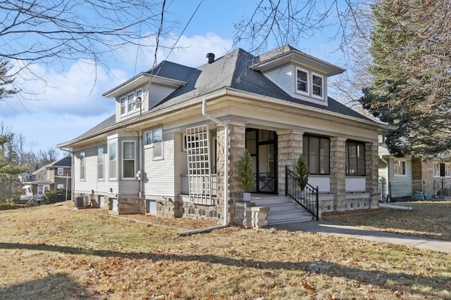 bungalow-style home featuring central AC unit and a front lawn