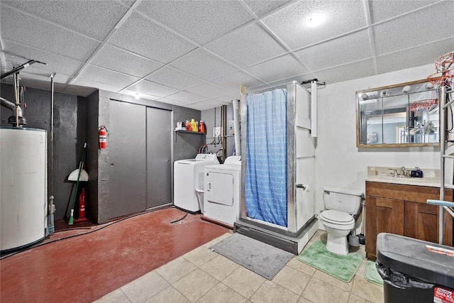 bathroom featuring washer and clothes dryer, a shower with shower curtain, vanity, gas water heater, and a drop ceiling