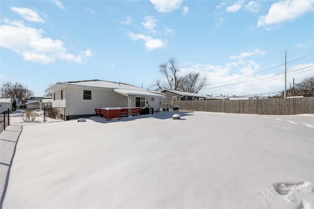 rear view of house with a jacuzzi