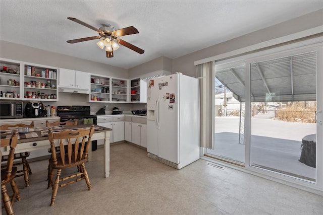 kitchen featuring white cabinetry, white refrigerator with ice dispenser, ceiling fan, a textured ceiling, and black / electric stove