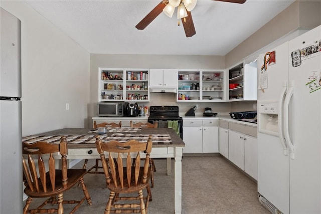 kitchen featuring white cabinetry, refrigerator, black range with electric cooktop, ceiling fan, and white refrigerator with ice dispenser