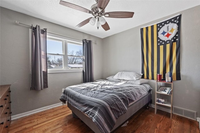 bedroom with dark hardwood / wood-style floors and ceiling fan