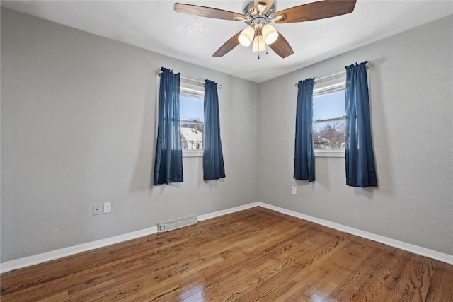 empty room featuring ceiling fan and wood-type flooring